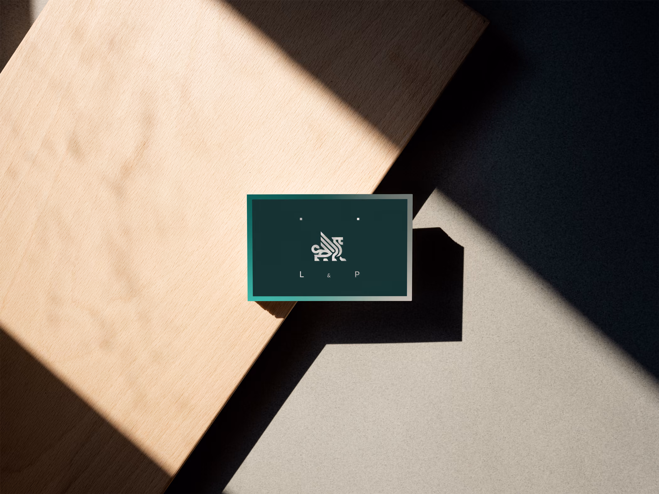 A business card with a green design and a lion signet.